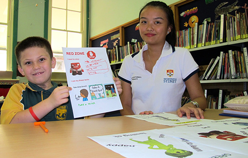 Sydney University occupational therapy student Monalisa Atmawijaya helping Kyogle Public School year 5 student Deacon Farrell.